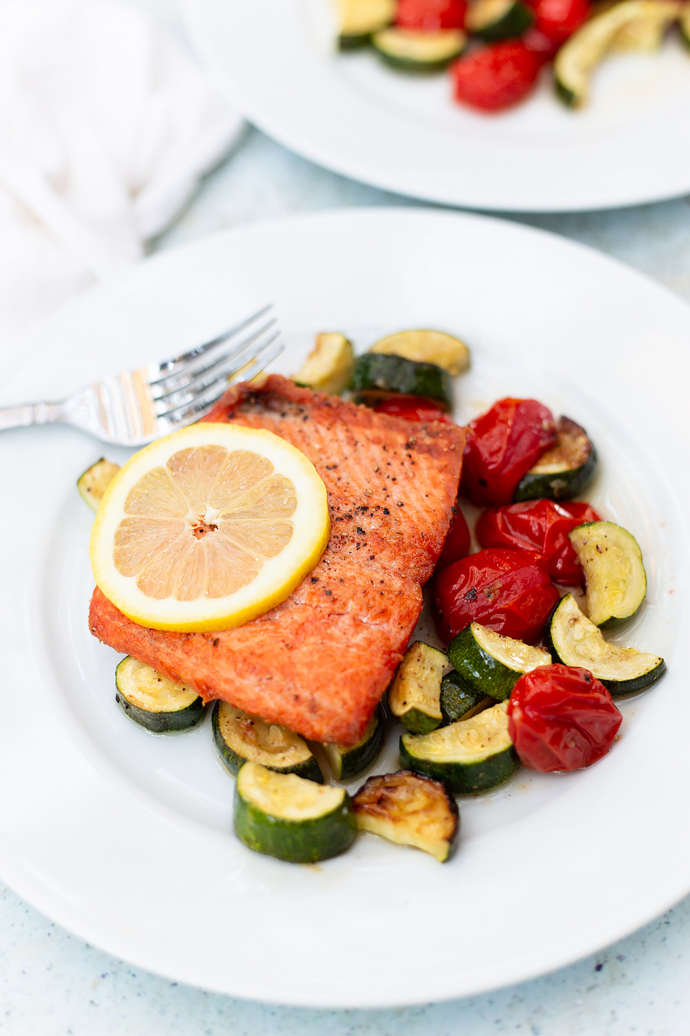 pan fried salmon with roasted veggies on a plate