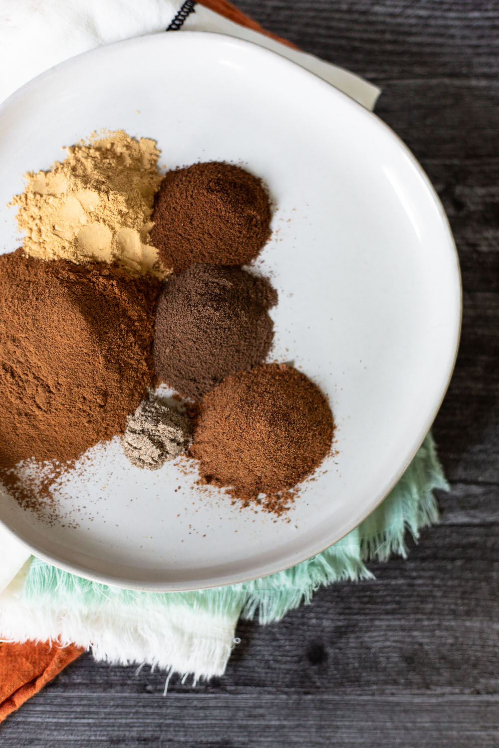 pumpkin pie spice ingredients on a plate.