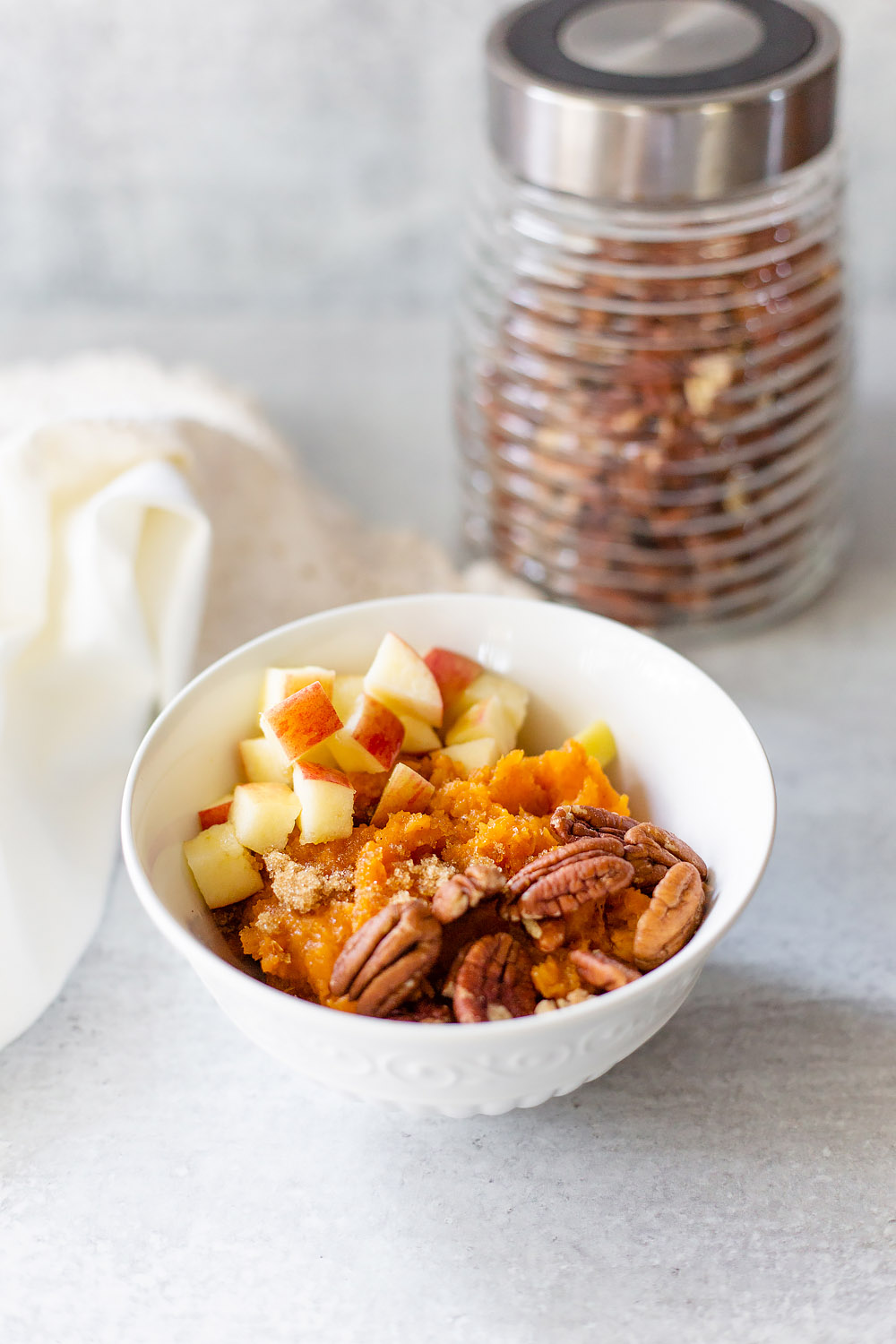 sweet potato bowl with pecans in the background