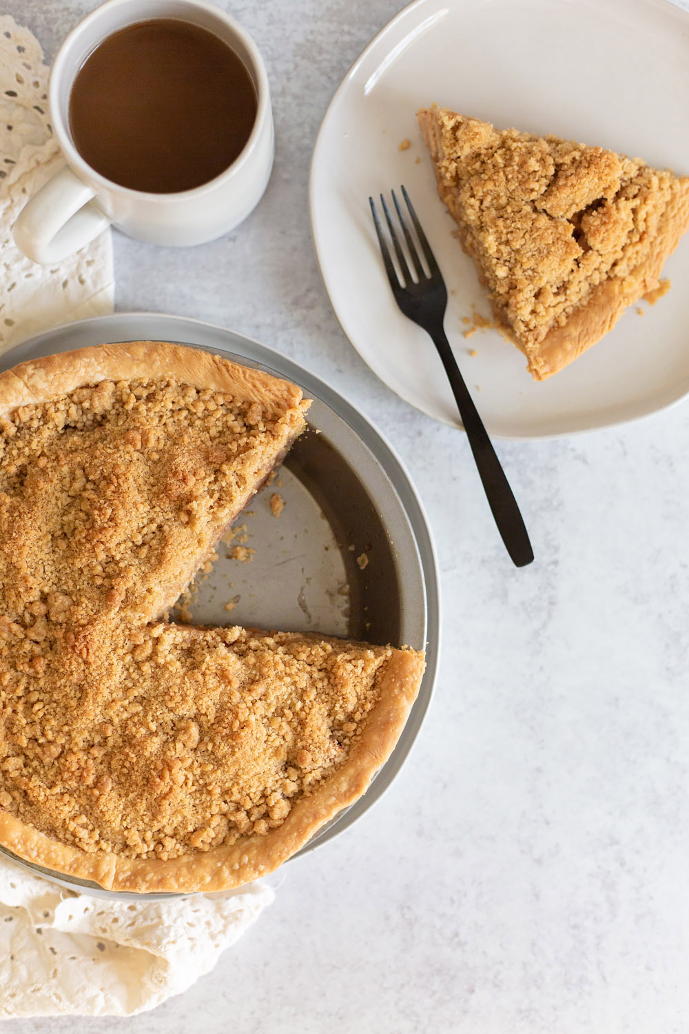 dutch apple pie in a pie tin with a slice of pie on the side