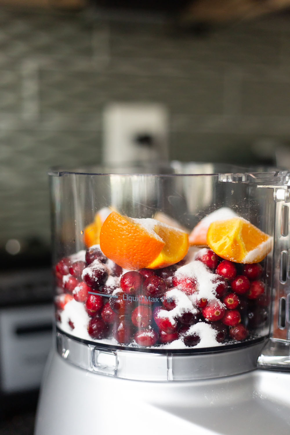 oranges, cranberries, and sugar in a food processor