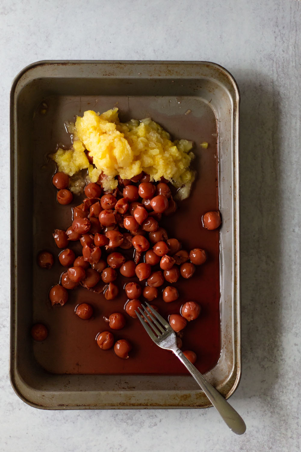 pineapples and cherries in a cake pan