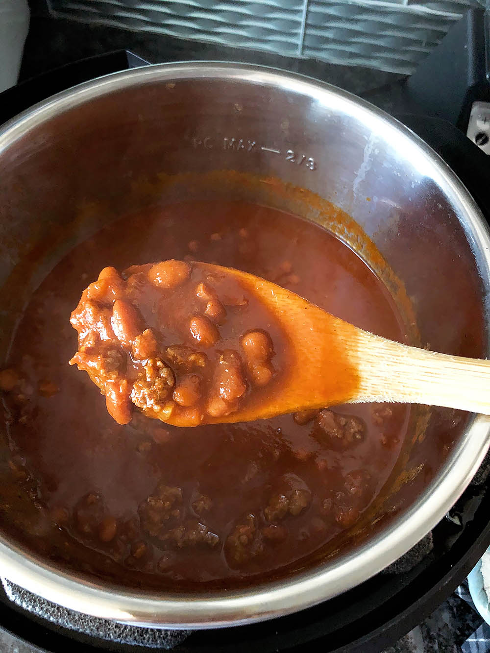 cooked chili on a spoon