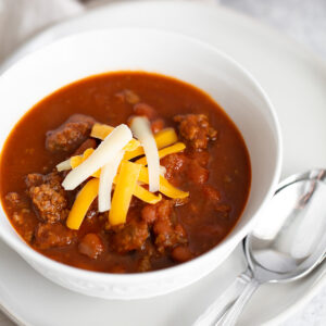 Chili in a bowl topped with cheese