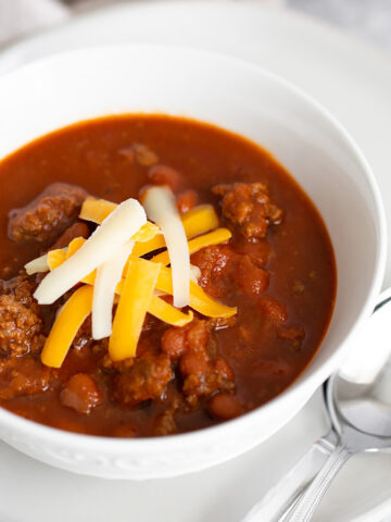 Chili in a bowl topped with cheese