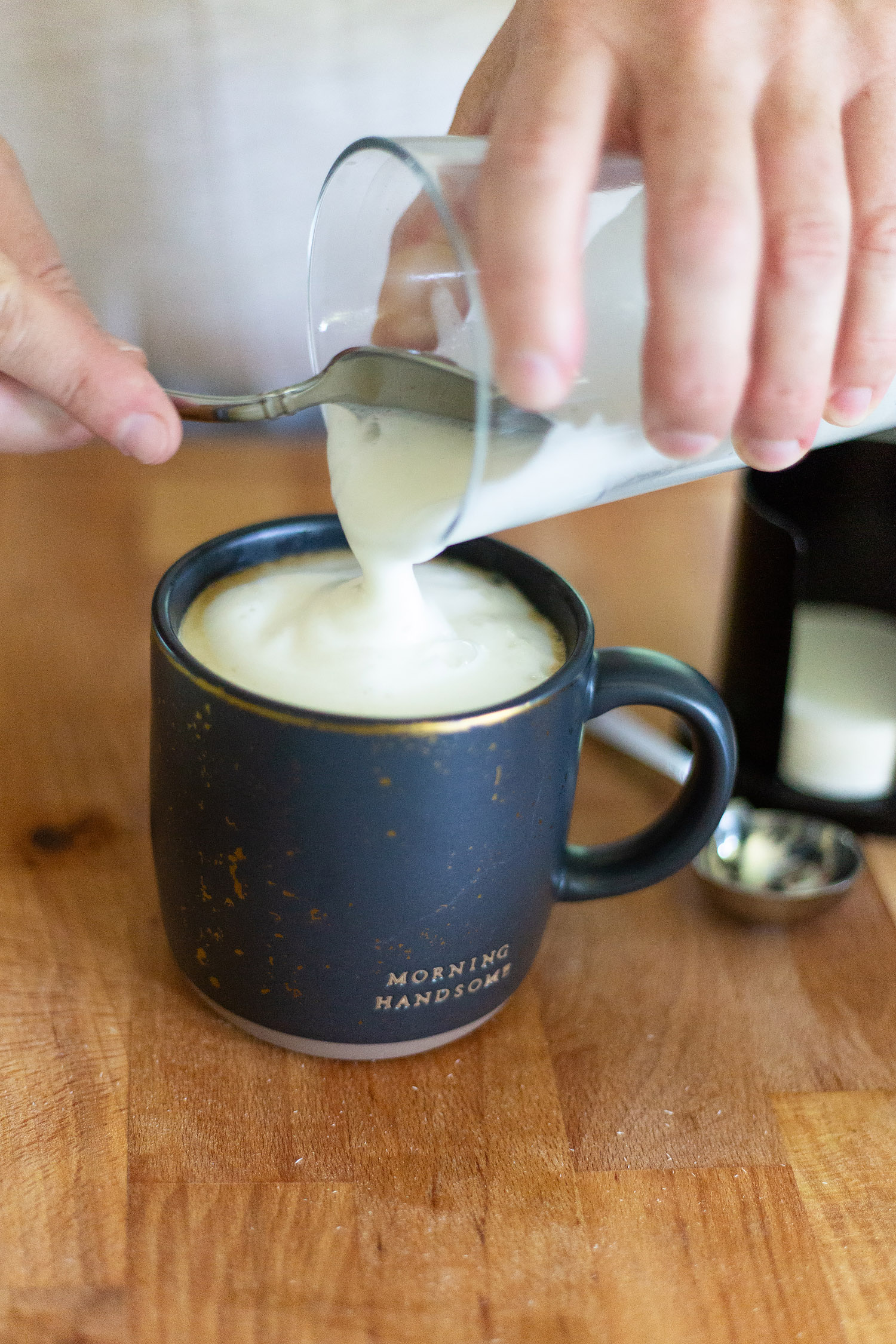 adding foamed milk to a cappuccino