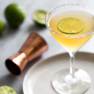 Italian margarita in a martini glass with a lime slice.