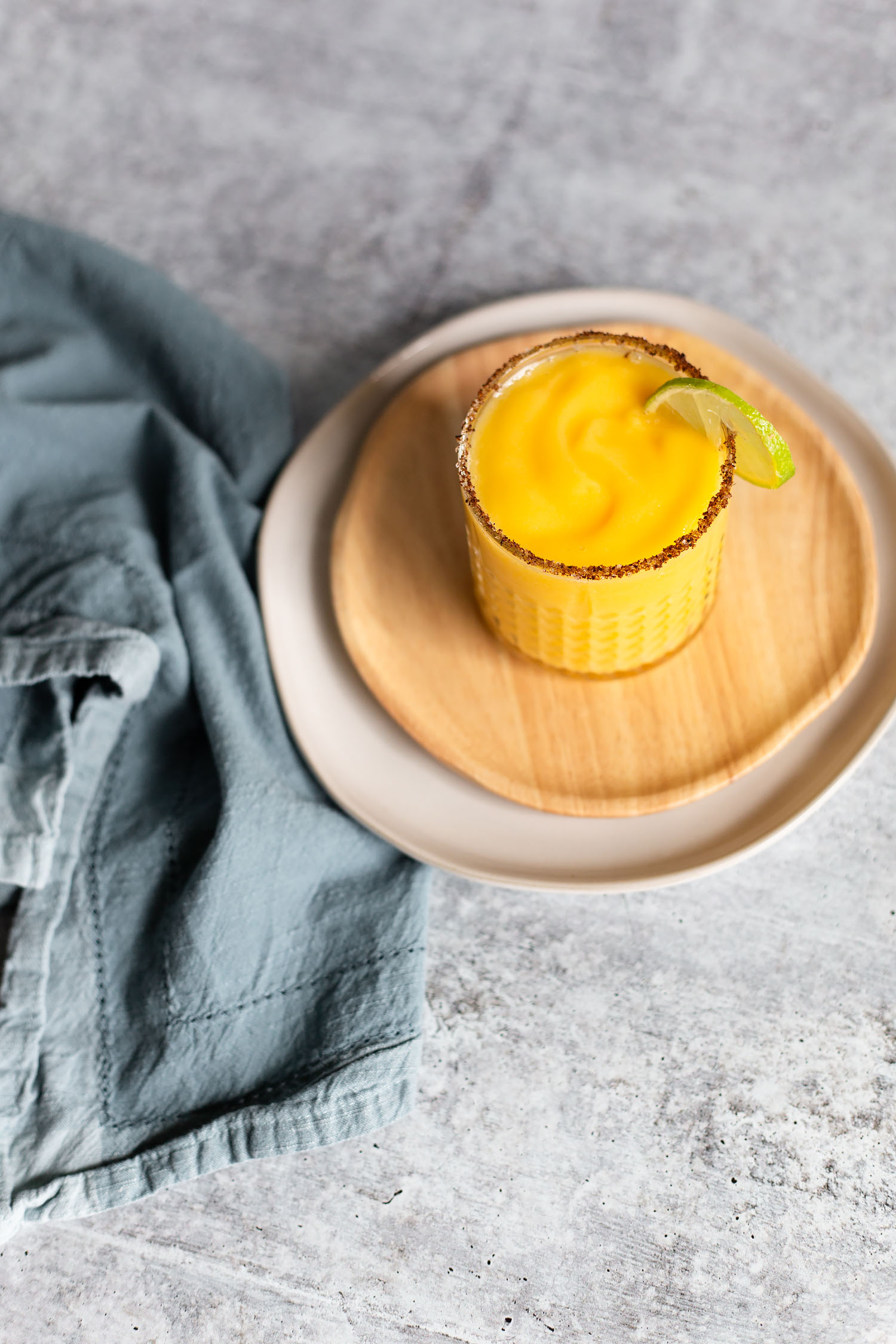 mango margarita with a lime slice