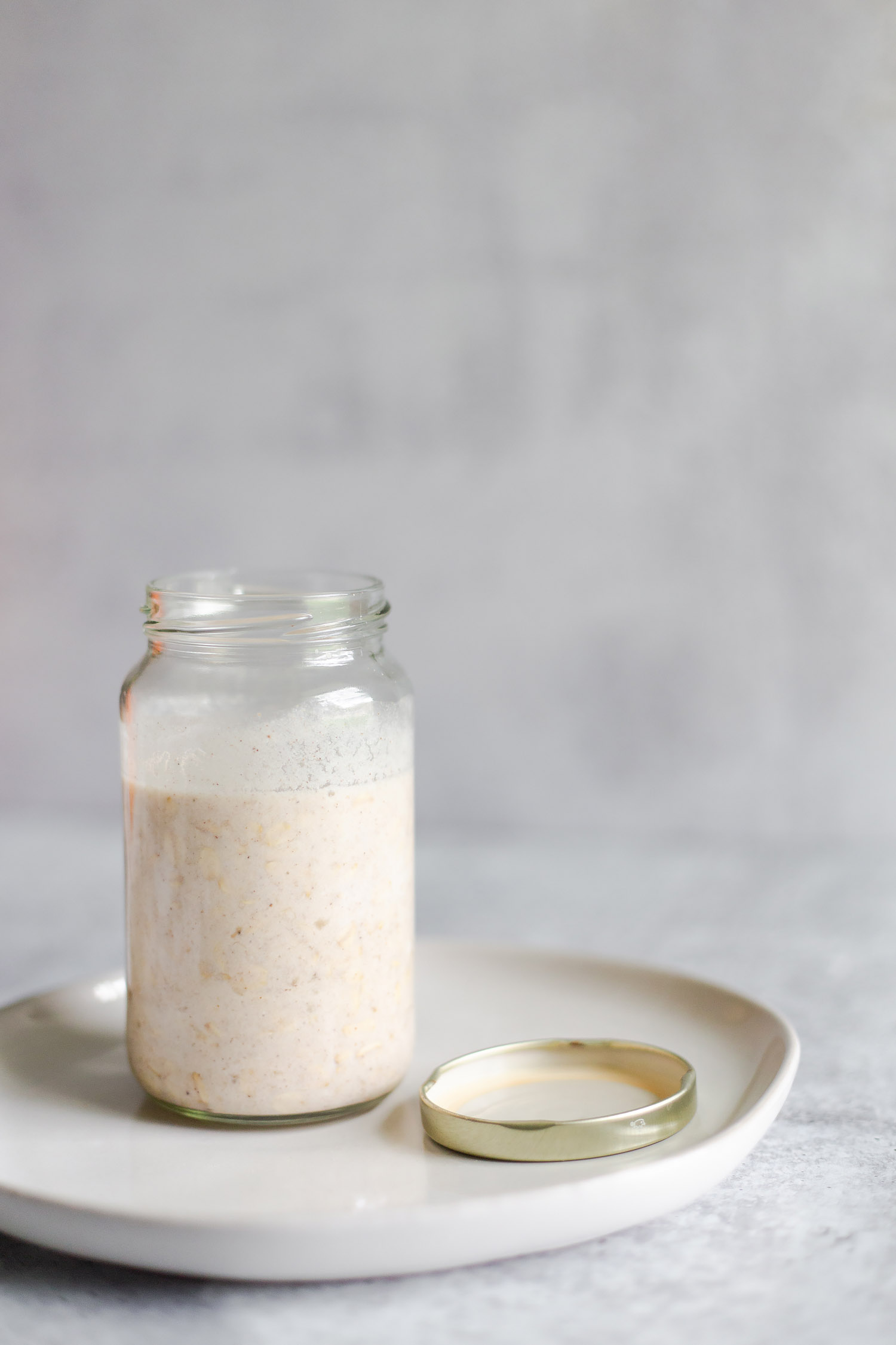 banana bread overnight oats in a jar with lid on the side