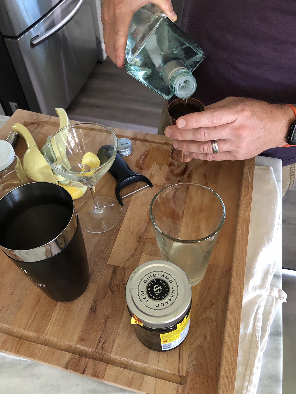 pouring gin for a cocktail