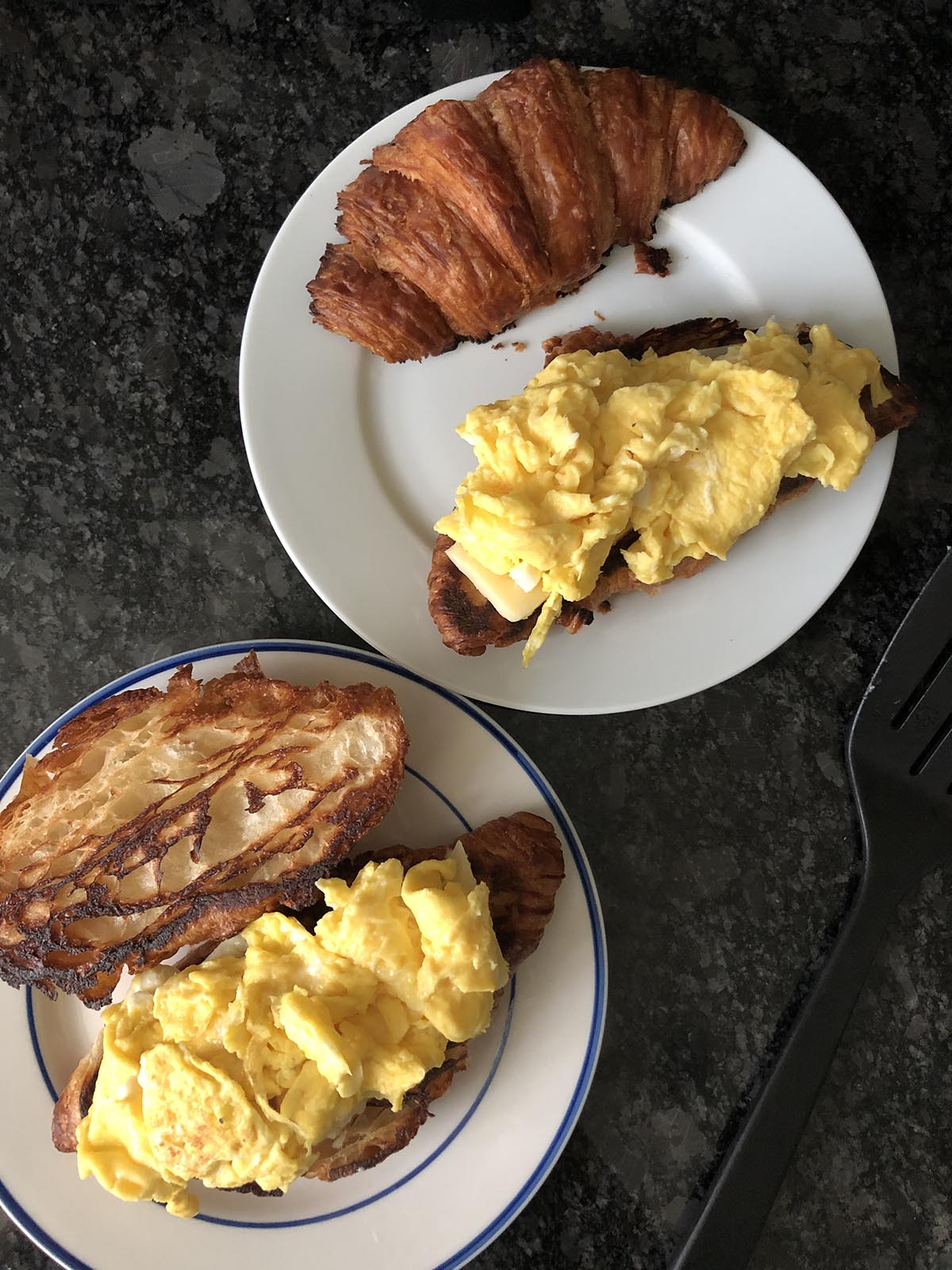 croissant topped with scrambled eggs