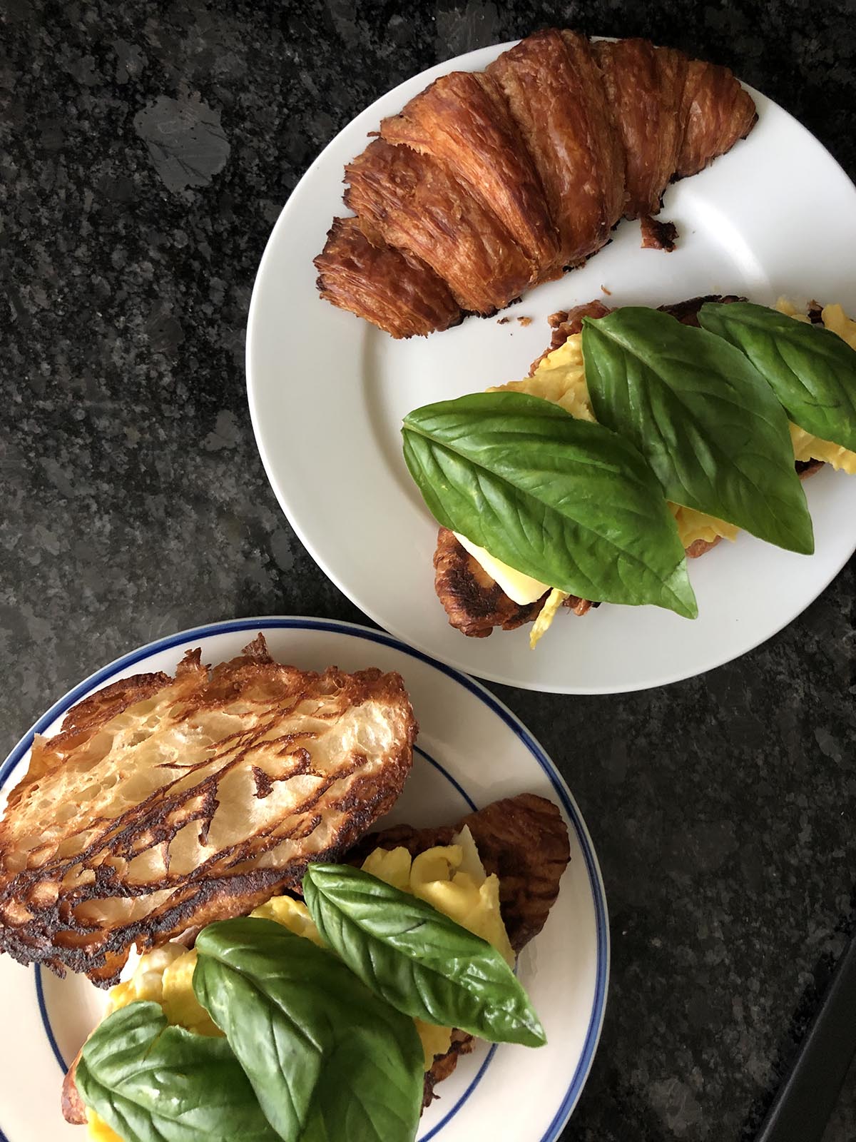 croissant topped with cheese eggs and basil