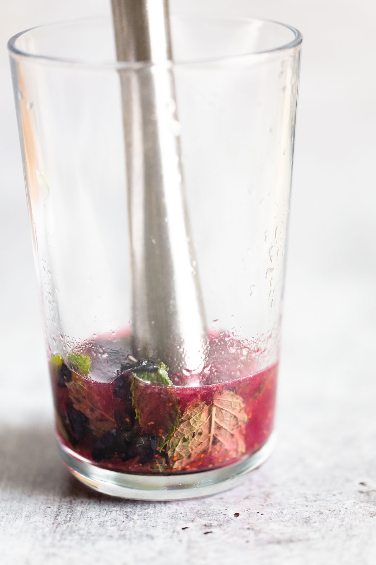 muddling together blueberries and mint