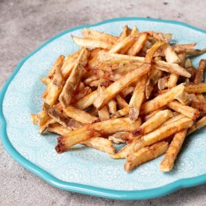 Battered french fries on a teal plate