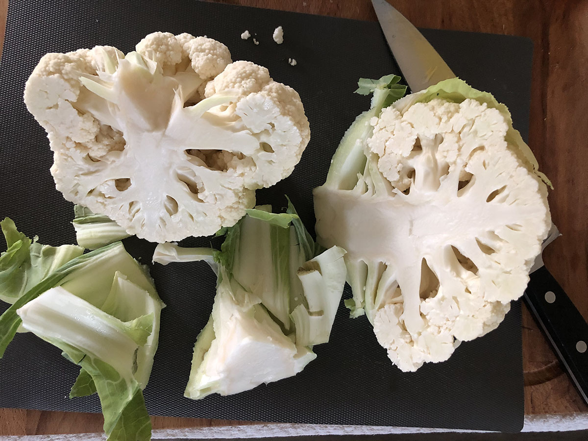 head of cauliflower being cut