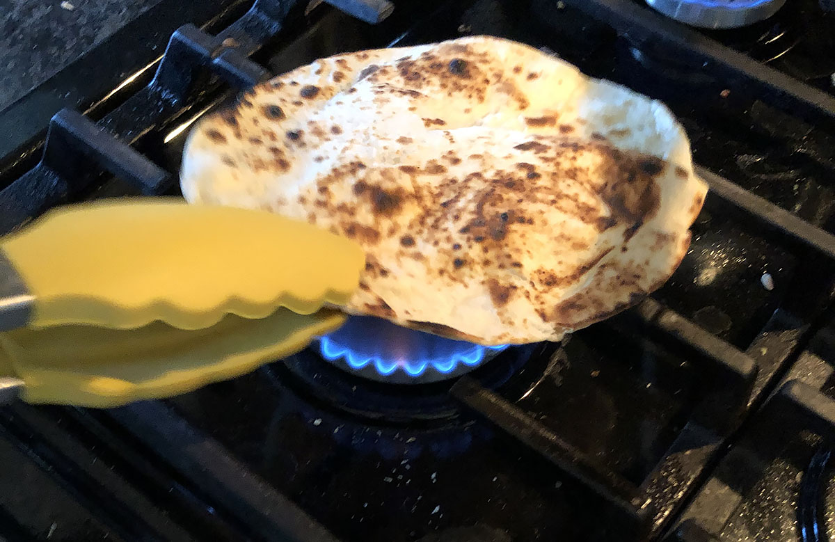 tortilla being toasted over a flame