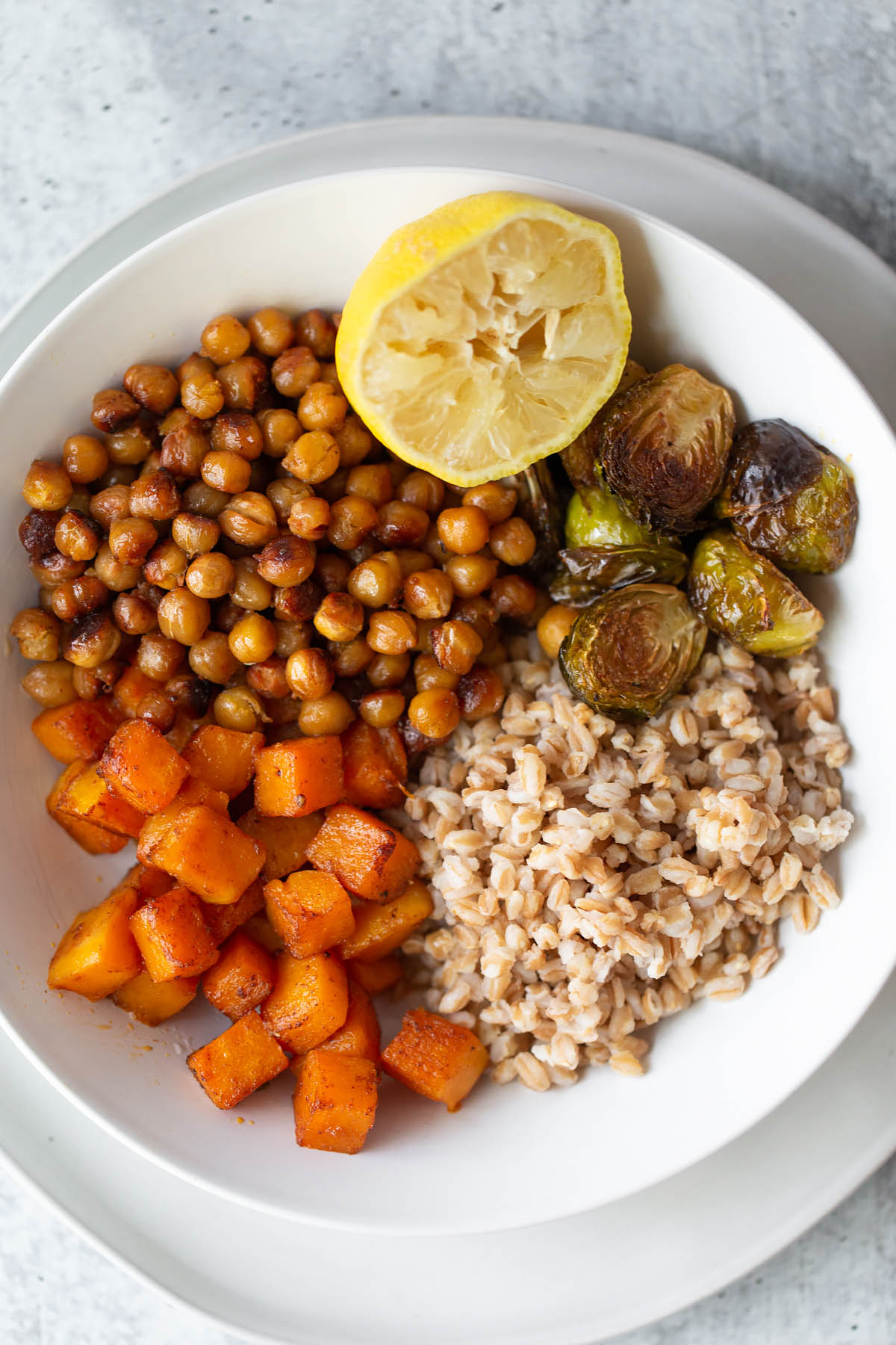 farro bowl up close with butternut squash chickpeas ad brussels sprouts