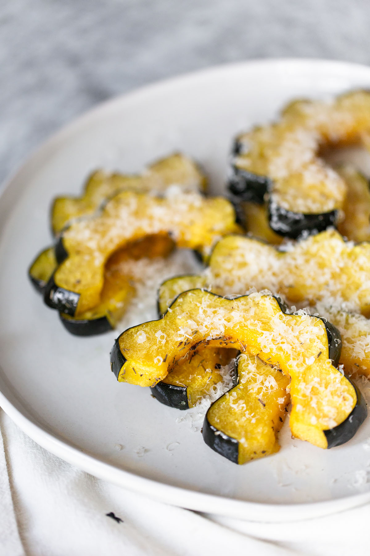 oven roasted acorn squash slices with parmesan cheese