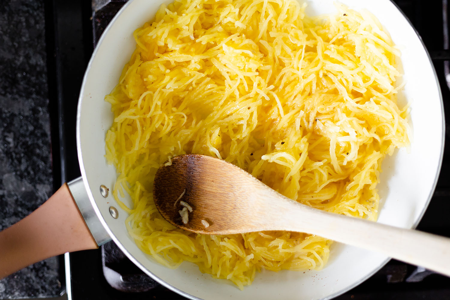 spaghetti squash sautéing in a pan