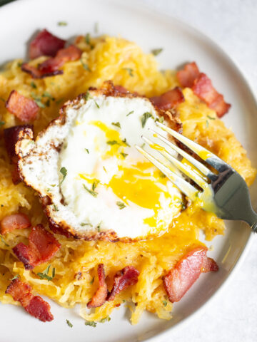 spaghetti squash carbonara with broken egg yolk