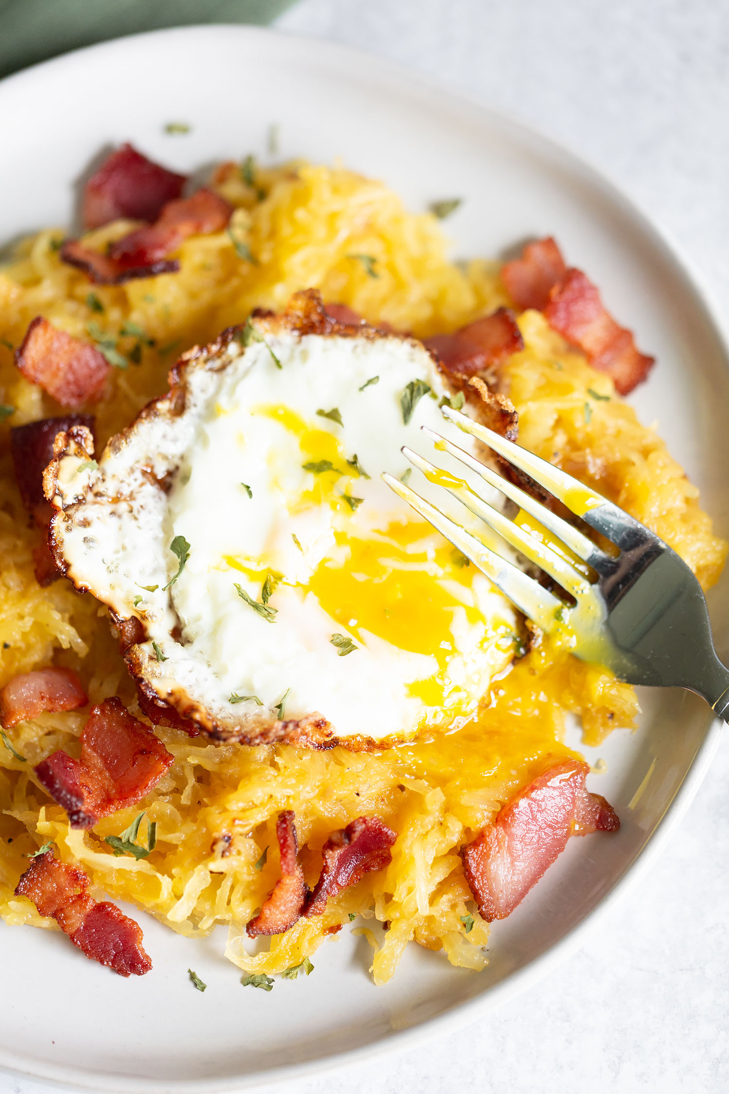 spaghetti squash carbonara with broken egg yolk