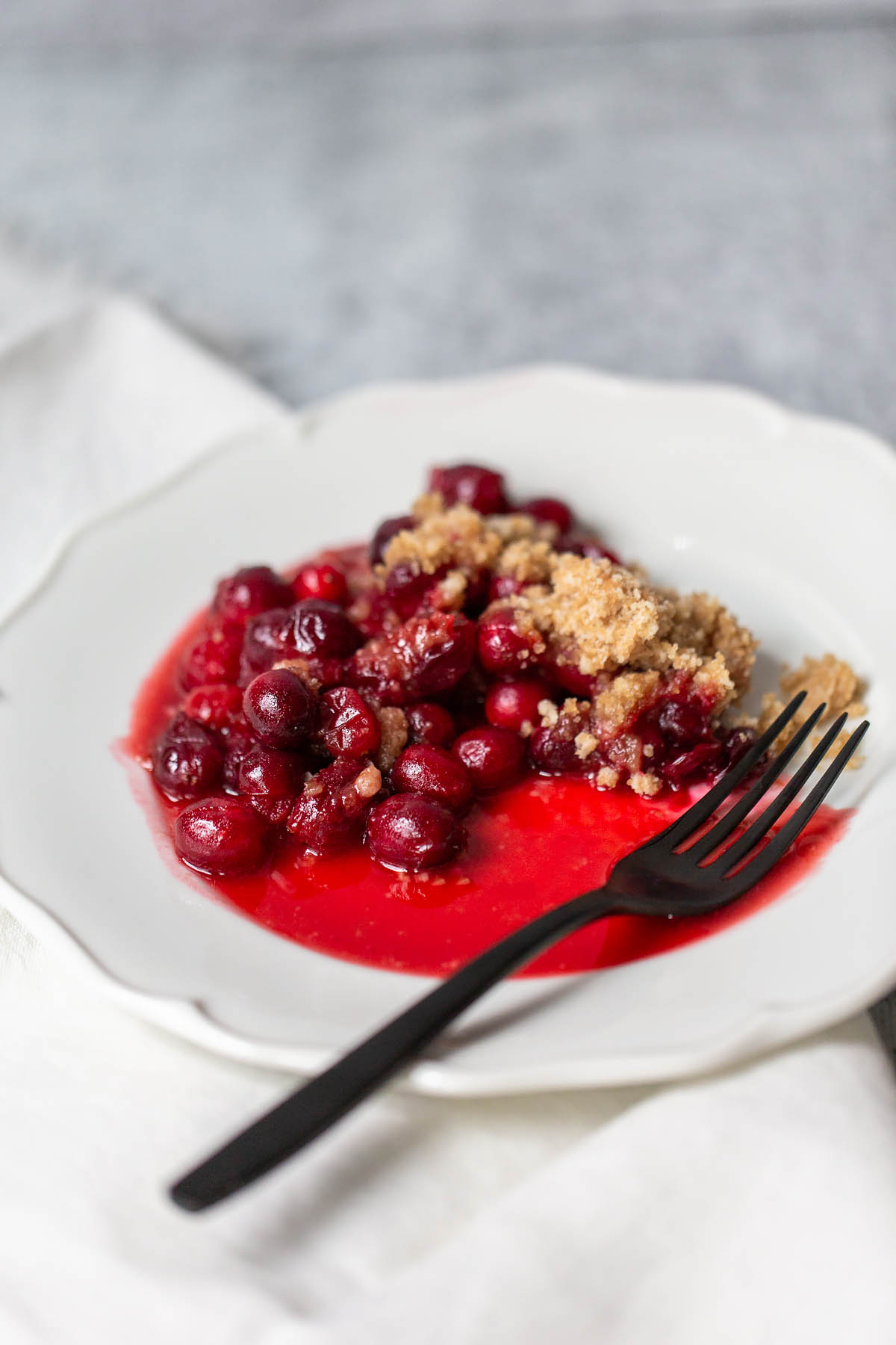 cranberry crumble on a plate with a fork