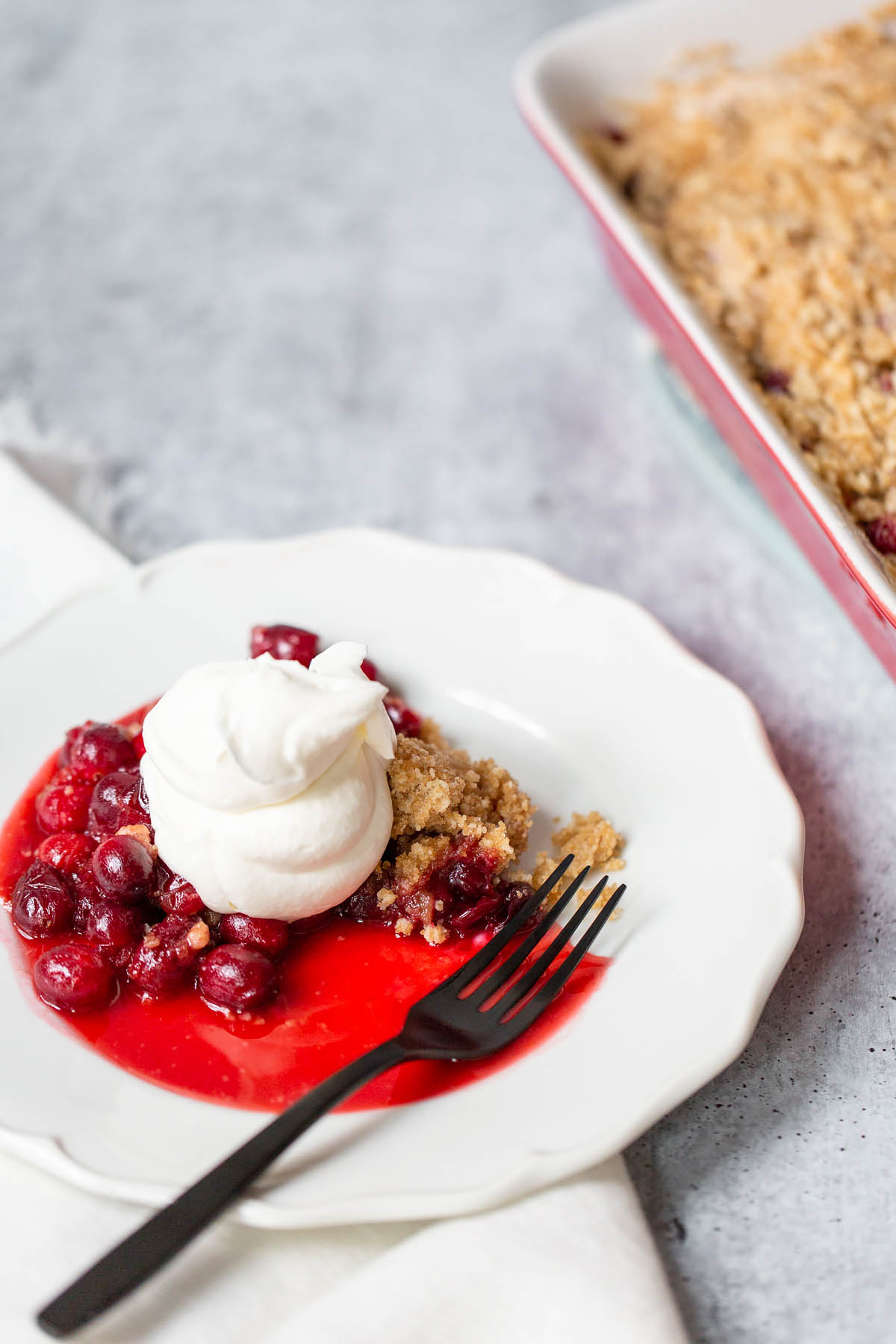 cranberry crisp topped with whipped cream