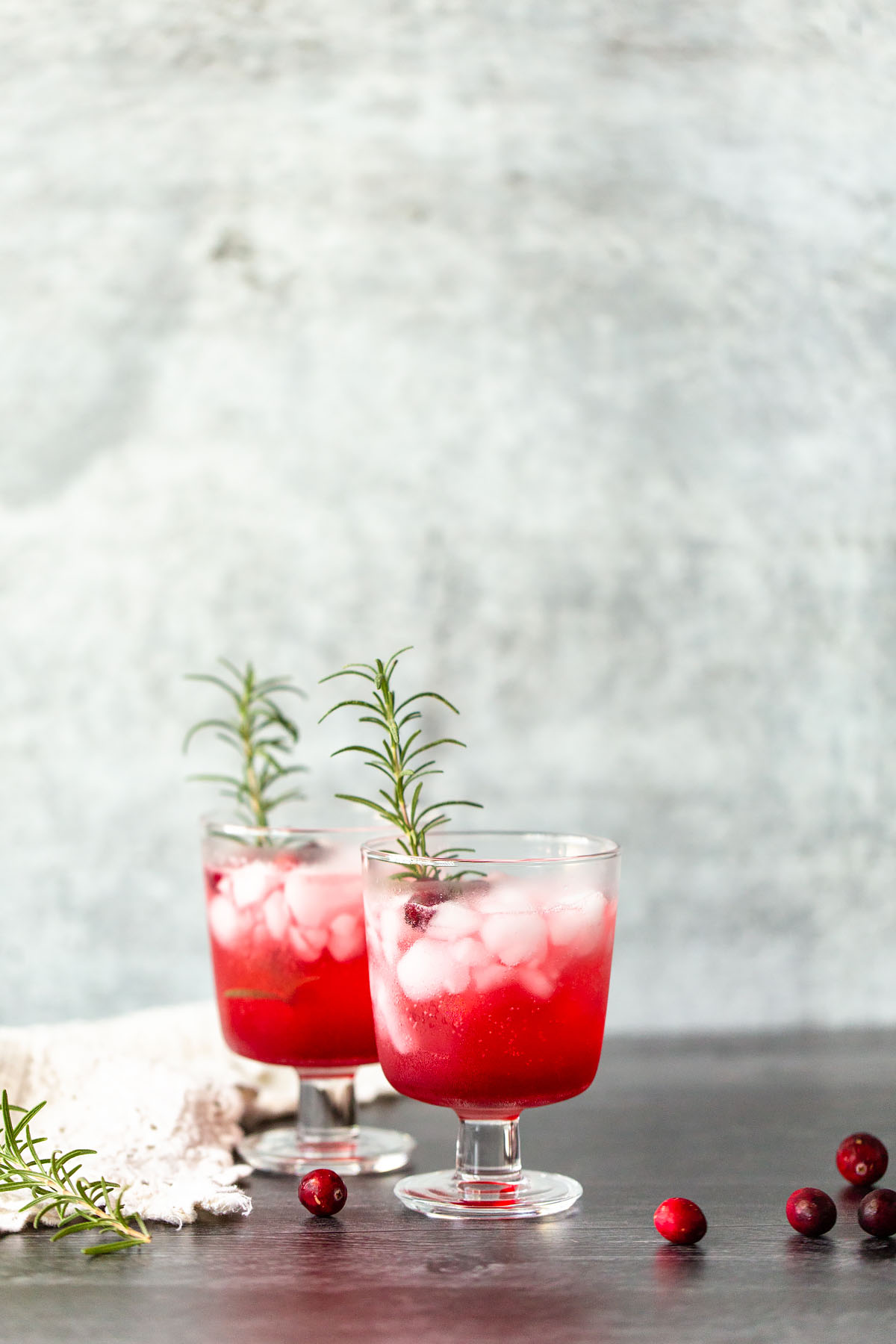 cranberry fizz mocktail with rosemary sprigs