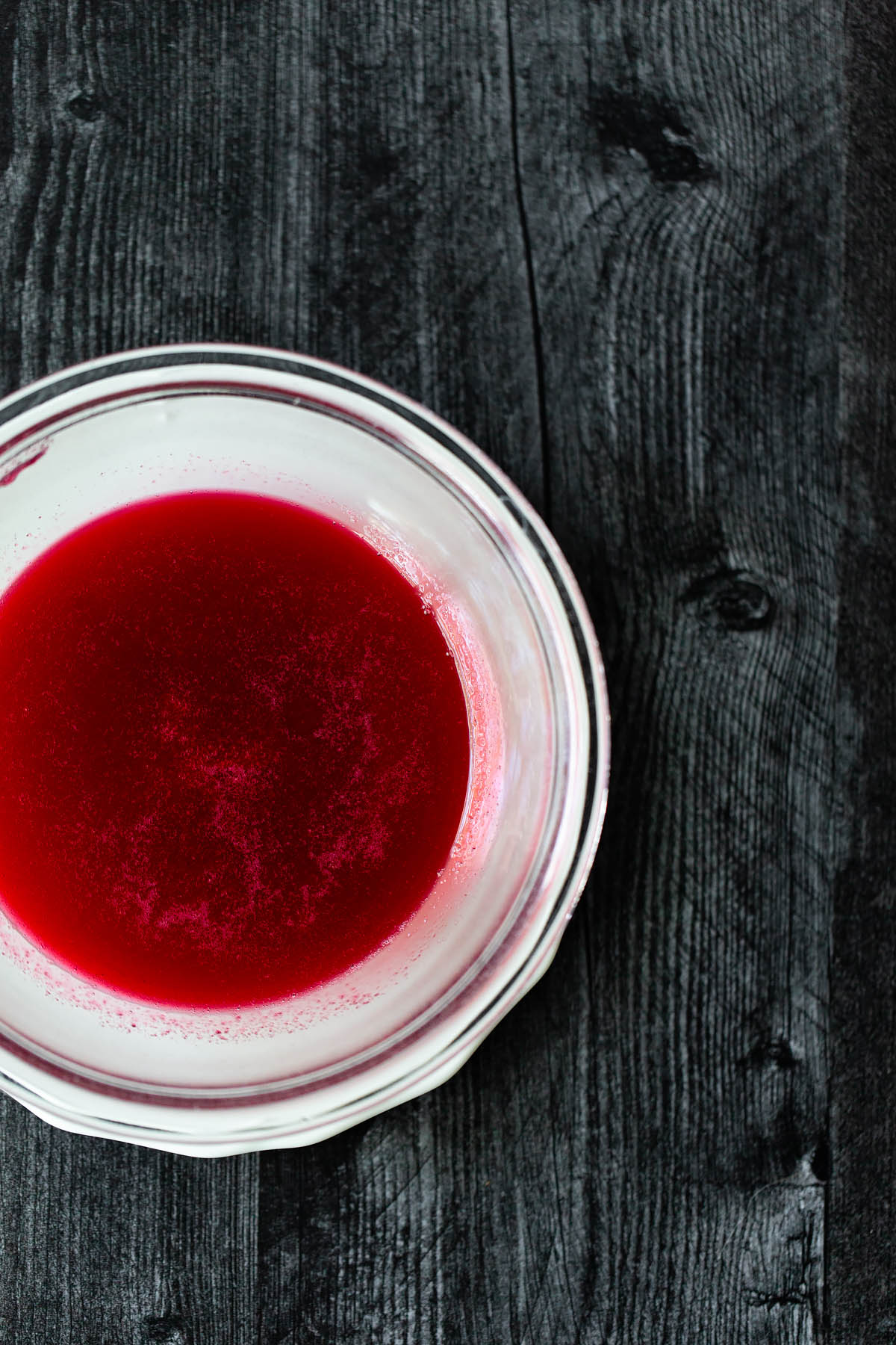 strained cranberry simple syrup in a bowl