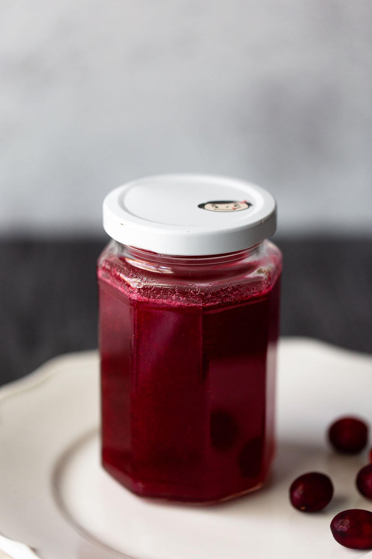 cranberry simple syrup up close in a jar