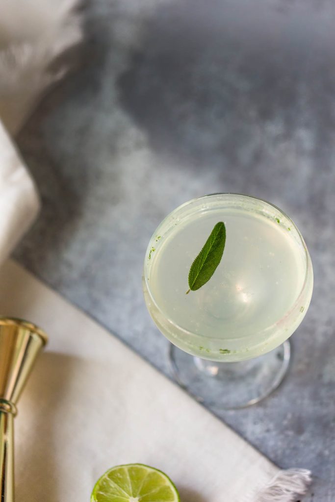 sage gimlet mocktail topped with a sage leaf