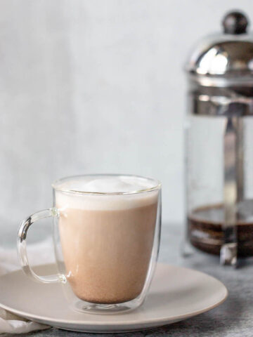 french press latte in a glass mug