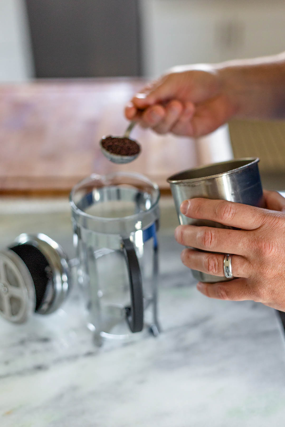 adding coffee grounds to a french press