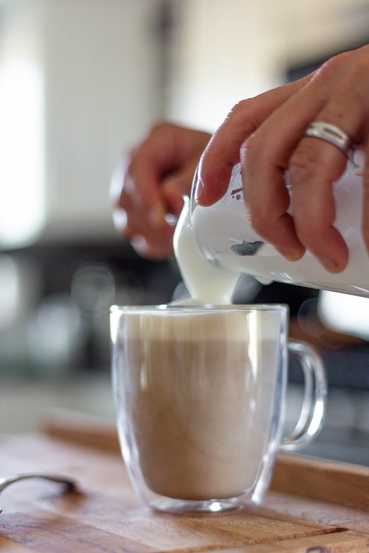 pouring foam onto a latte