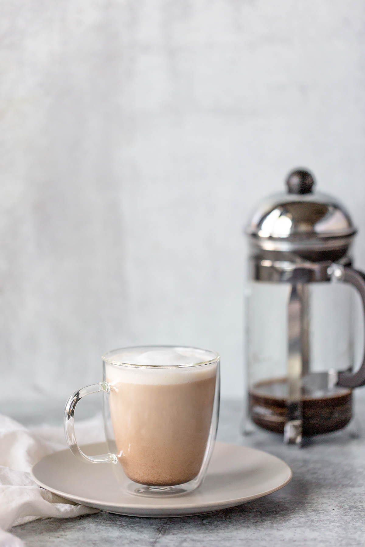 french press latte in a glass mug