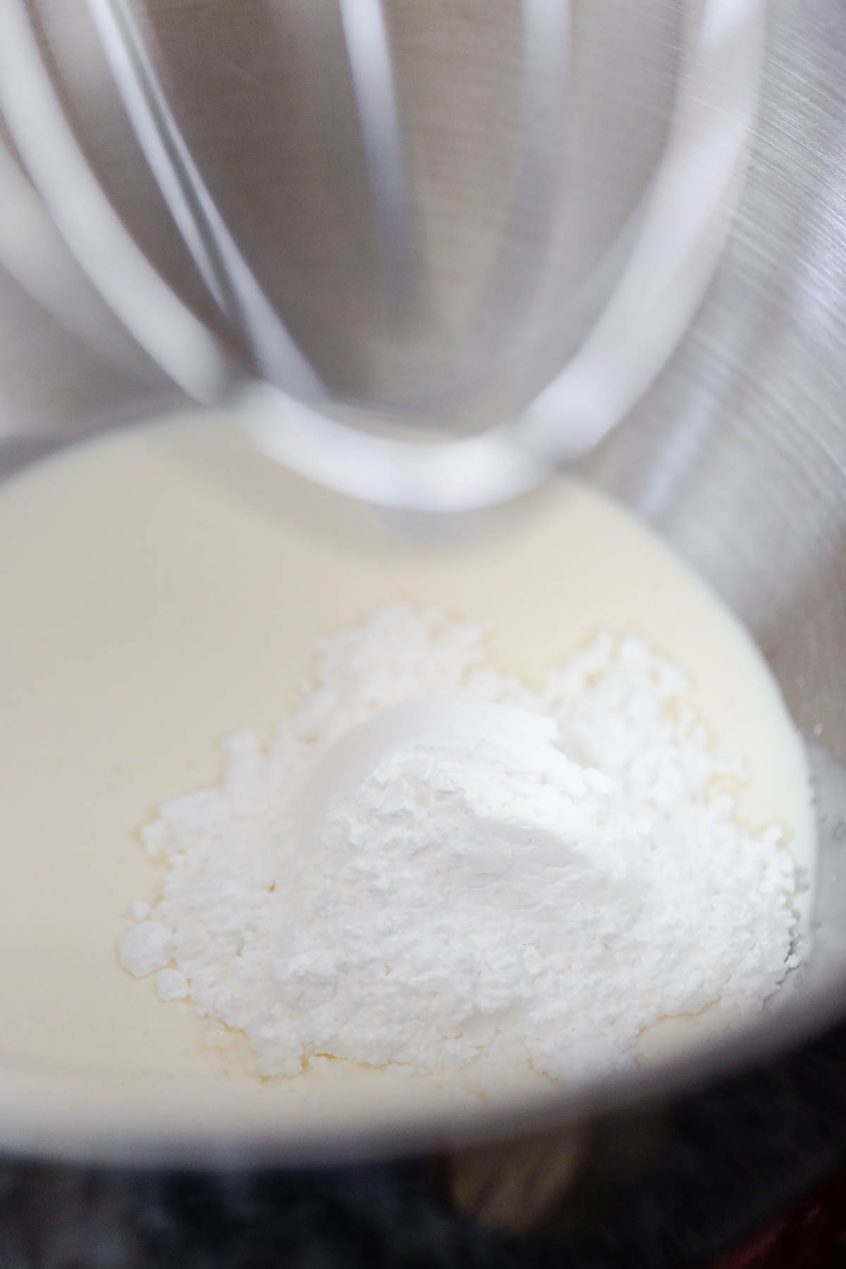 heavy cream and powdered sugar in a mixing bowl