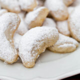 walnut crescent cookies on a plate