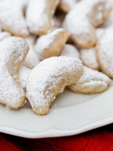 walnut crescent cookies on a plate