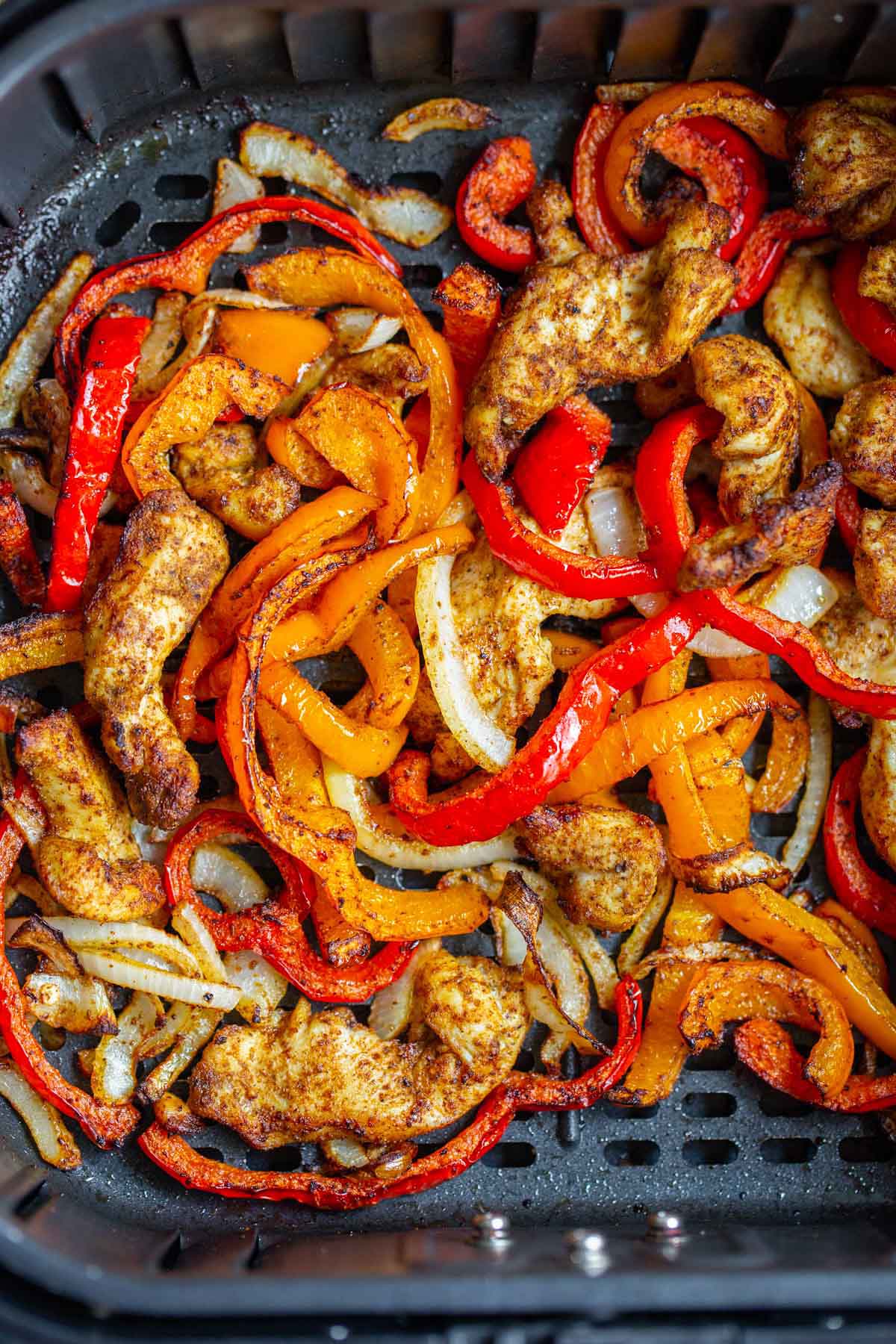 Cooked chicken fajitas in air fryer basket