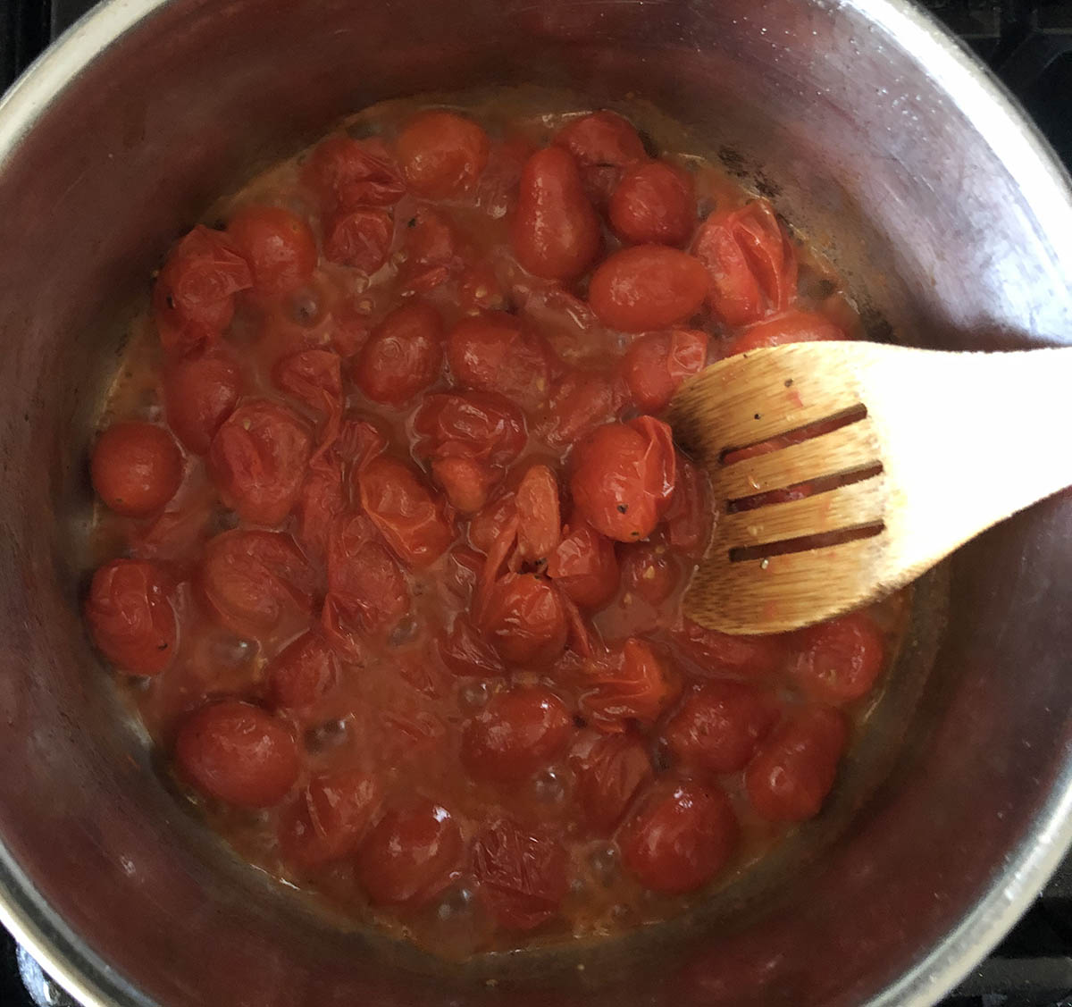 cooked cherry tomatoes in a pot