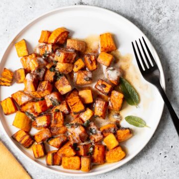 sweet potatoes on a plate with sage leaves