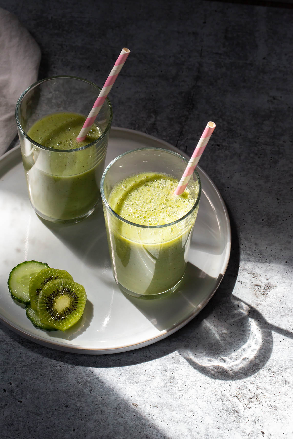 kiwi and cucumber smoothies with a straw