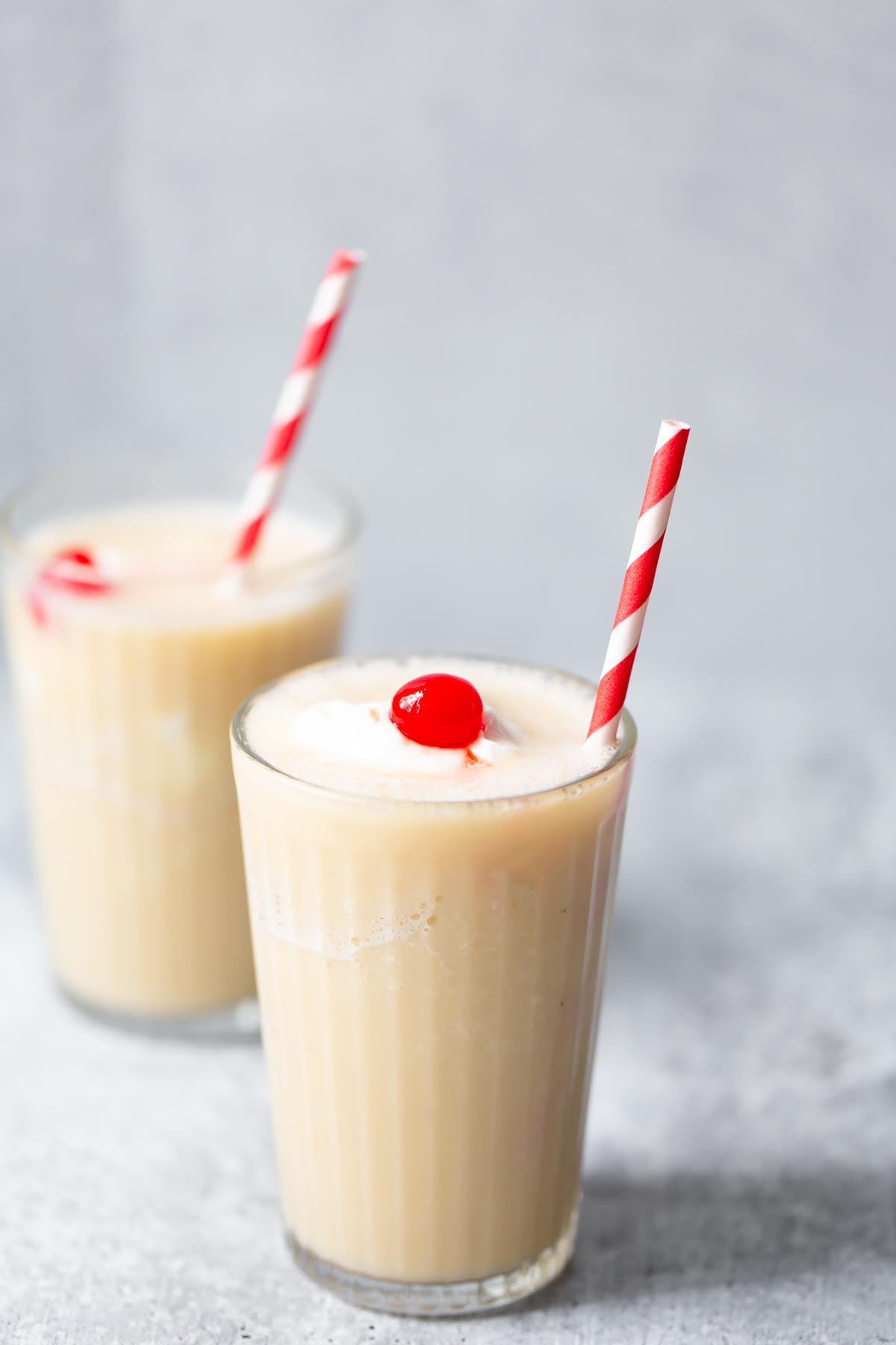 pineapple banana smoothie with a cherry