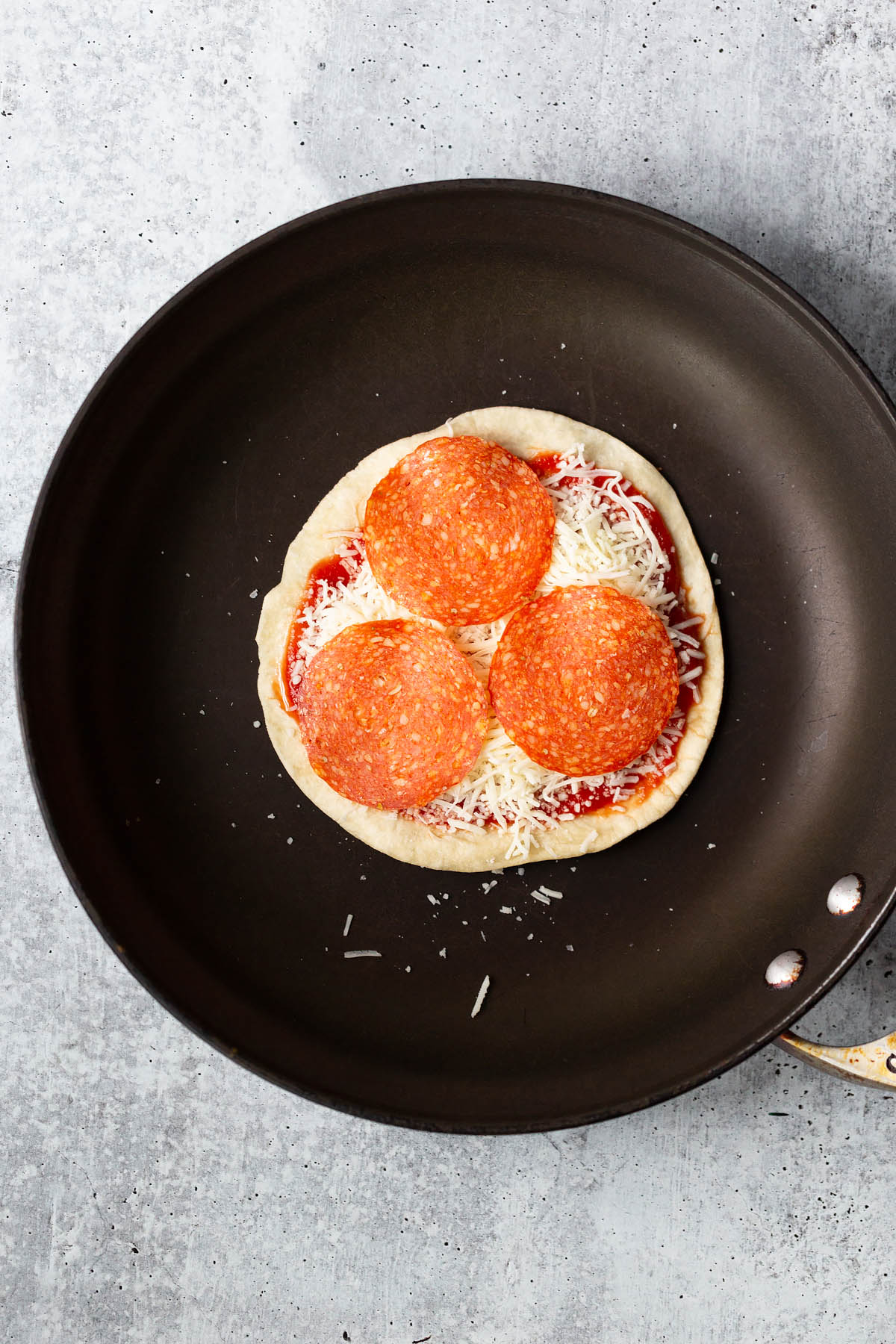 making a pizza quesadilla with pepperoni