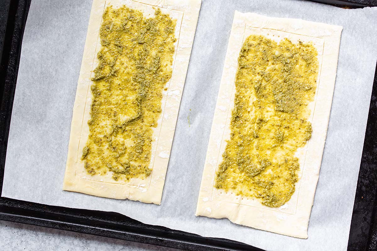 pesto on two sheets of puff pastry