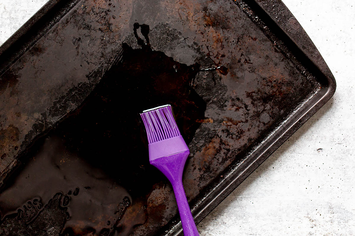 spreading oil onto a sheet pan