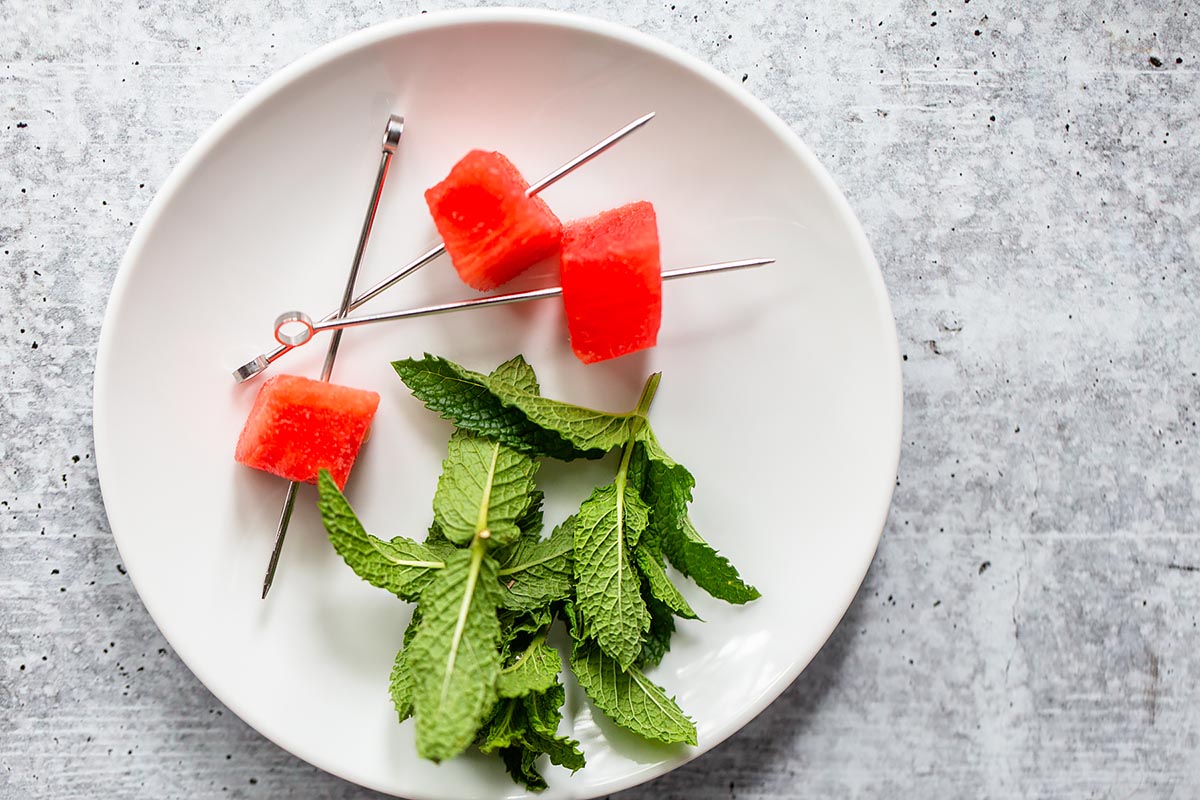 skewered watermelon and mint on a plate