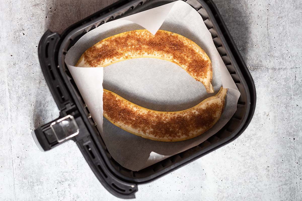 sliced banana in an air fryer basket