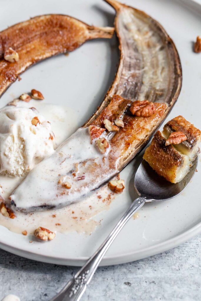 caramelized banana with melted ice cream and a spoon