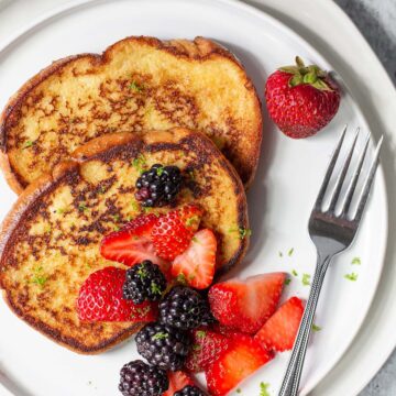 coconut lime french toast topped with blackberries and strawberries